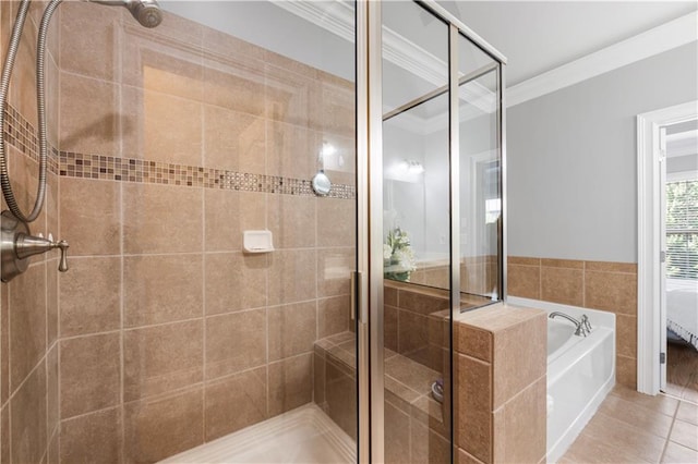 bathroom featuring ornamental molding, a garden tub, a stall shower, and tile patterned flooring