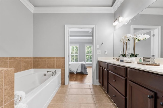 ensuite bathroom with crown molding, double vanity, tile patterned flooring, and a garden tub