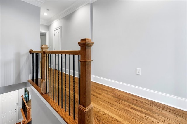 stairs featuring ornamental molding, wood finished floors, baseboards, and recessed lighting