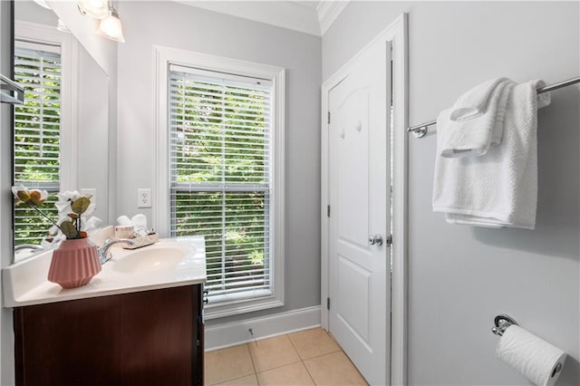 bathroom featuring crown molding, tile patterned flooring, vanity, and baseboards