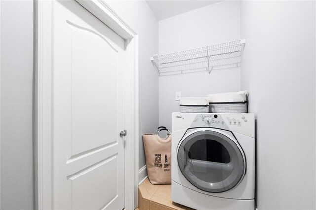 washroom featuring washer / clothes dryer and tile patterned flooring