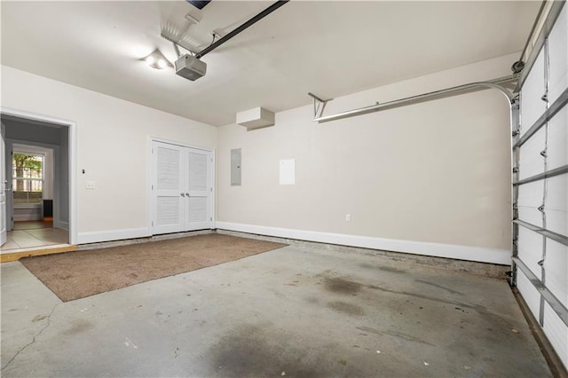 garage featuring a garage door opener, electric panel, baseboards, and french doors