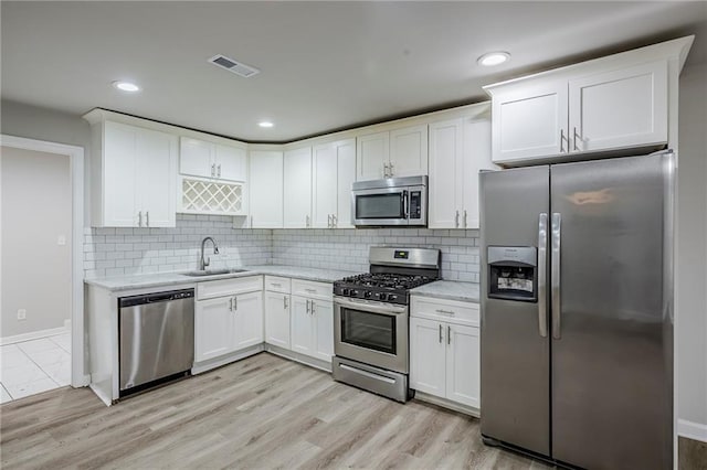 3735 Boulder Park Dr SW, Atlanta, GA 30331 - kitchen with appliances with stainless steel finishes, a sink, white cabinetry, light stone counters, and recessed lighting