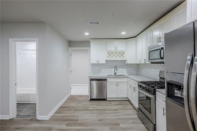 3735 Boulder Park Dr SW, Atlanta, GA 30331 - kitchen with appliances with stainless steel finishes, a sink, light countertops, white cabinetry, and recessed lighting