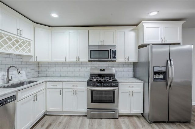 3735 Boulder Park Dr SW, Atlanta, GA 30331 - kitchen with stainless steel appliances, a sink, light wood finished floors, white cabinets, and recessed lighting