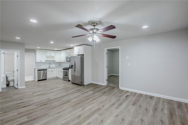 3735 Boulder Park Dr SW, Atlanta, GA 30331 - kitchen featuring appliances with stainless steel finishes, light wood-type flooring, recessed lighting, white cabinets, and baseboards