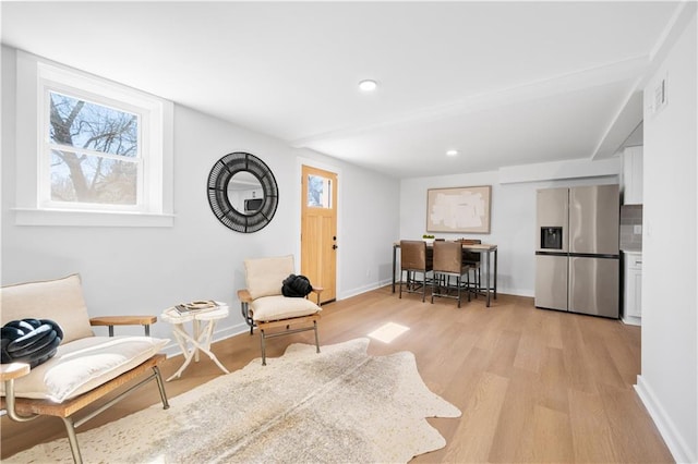 sitting room featuring light wood-style flooring, visible vents, baseboards, and recessed lighting