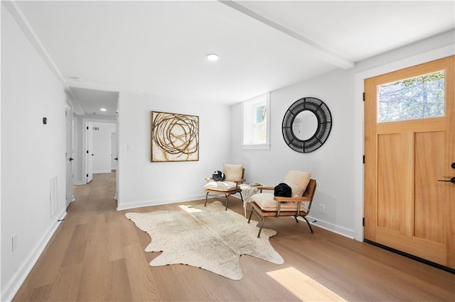 sitting room featuring recessed lighting, beam ceiling, baseboards, and wood finished floors