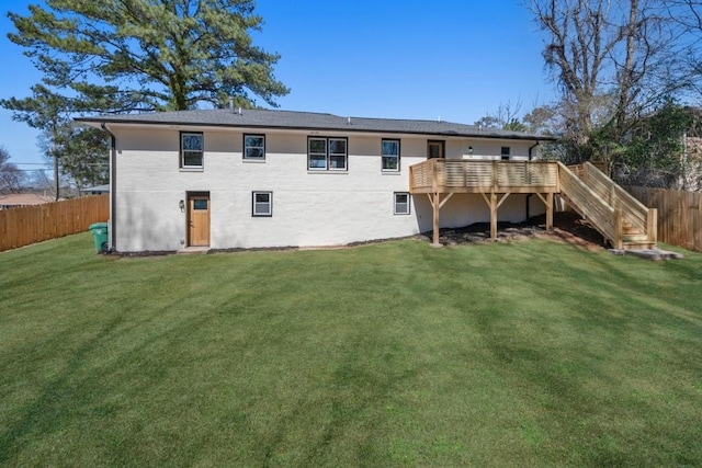 rear view of property featuring stairs, fence, a deck, and a yard