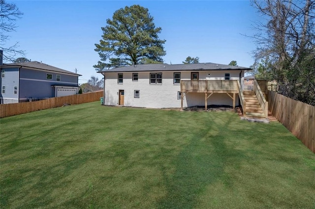 rear view of property featuring a fenced backyard, a yard, a deck, and stairs