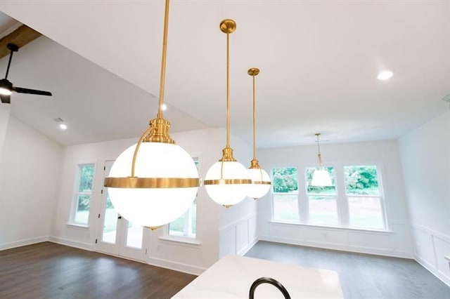 interior space featuring ceiling fan, dark hardwood / wood-style flooring, hanging light fixtures, and lofted ceiling