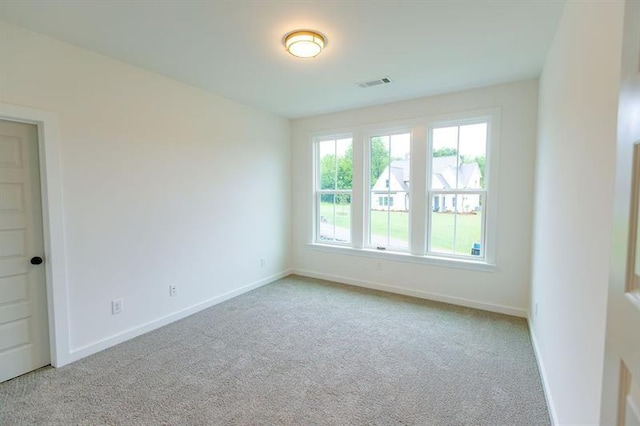 unfurnished room with light carpet