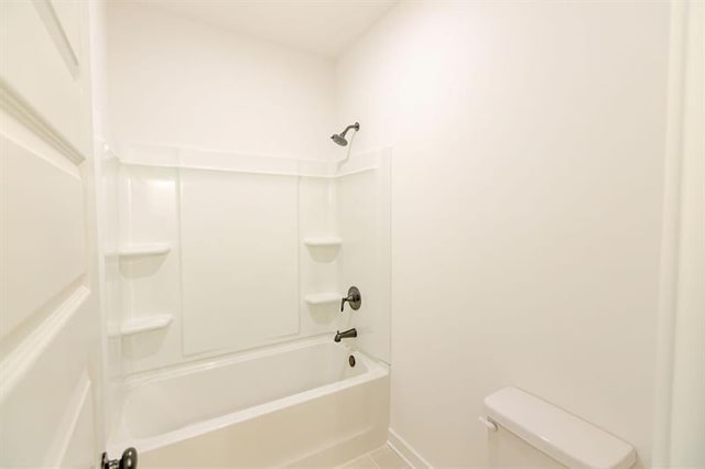 bathroom featuring shower / tub combination and toilet