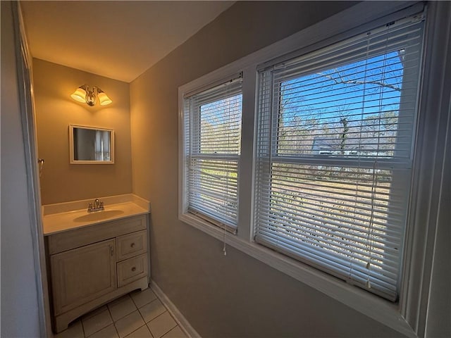 bathroom with tile patterned floors, baseboards, and vanity