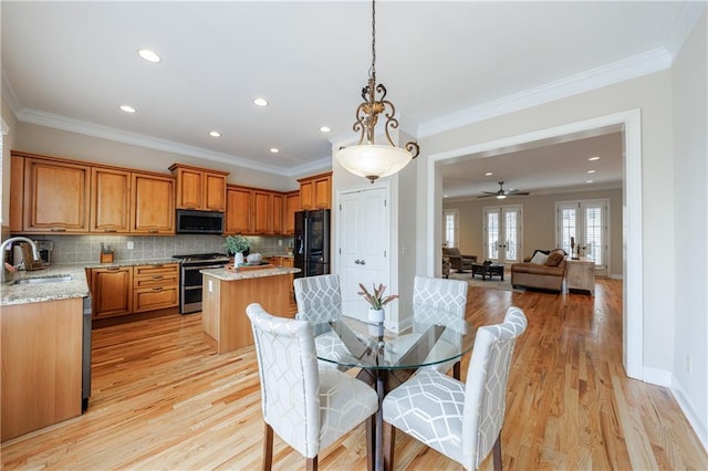 dining area featuring crown molding, recessed lighting, baseboards, and light wood finished floors