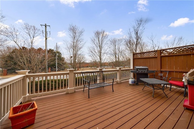 wooden terrace with a grill