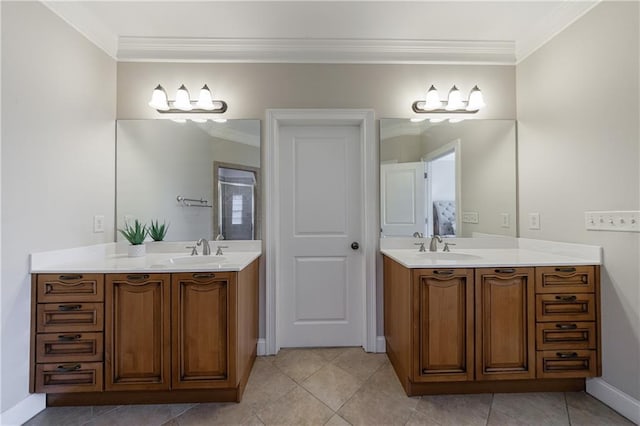 bathroom with crown molding, two vanities, and a sink