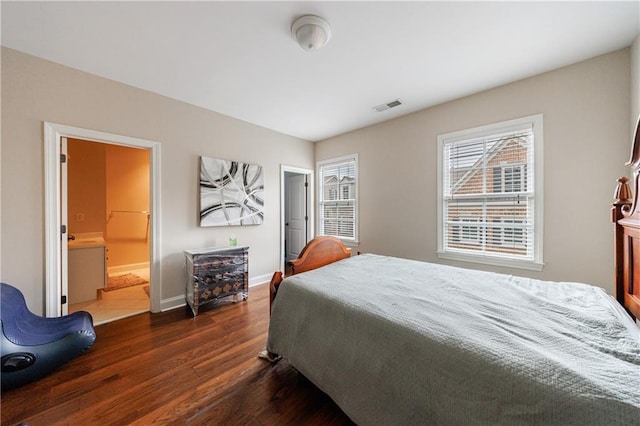 bedroom with visible vents, dark wood-type flooring, and baseboards