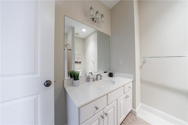 bathroom with visible vents, baseboards, vanity, and tile patterned flooring