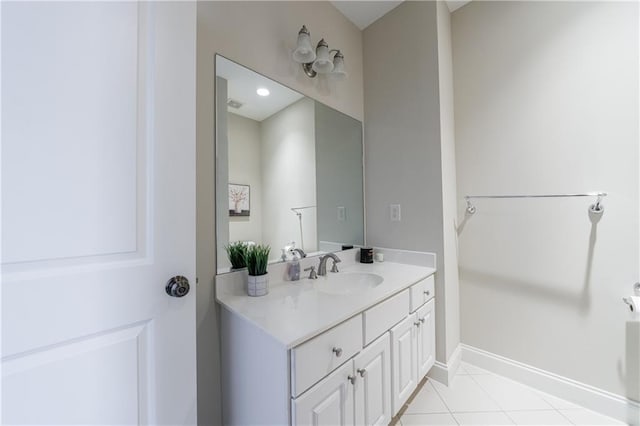 bathroom featuring tile patterned floors, baseboards, and vanity
