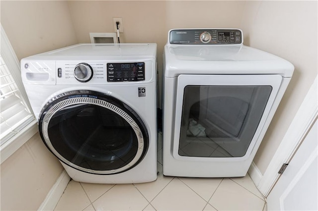 laundry area featuring tile patterned flooring, laundry area, and independent washer and dryer