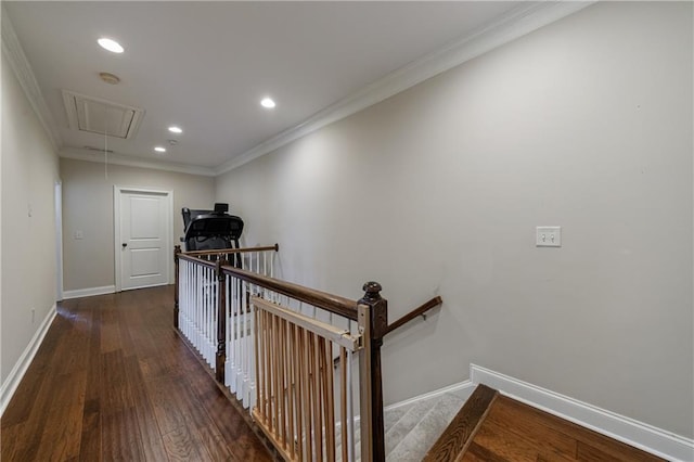 corridor featuring crown molding, baseboards, attic access, an upstairs landing, and wood finished floors