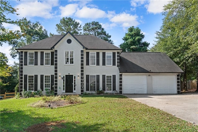 colonial-style house featuring a front lawn and a garage