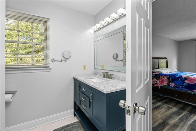 bathroom featuring a textured ceiling, hardwood / wood-style flooring, and vanity