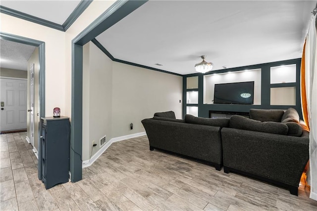 living room featuring crown molding and light hardwood / wood-style floors