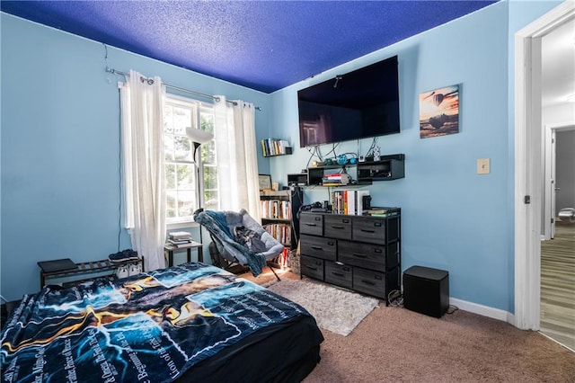 carpeted bedroom featuring a textured ceiling