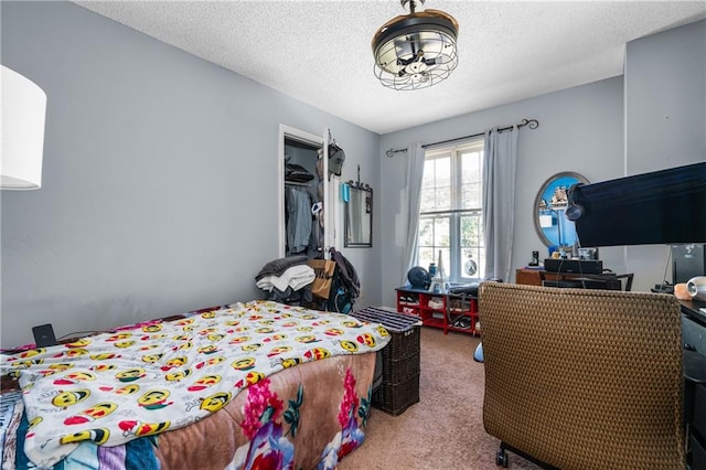 carpeted bedroom with a textured ceiling and a closet