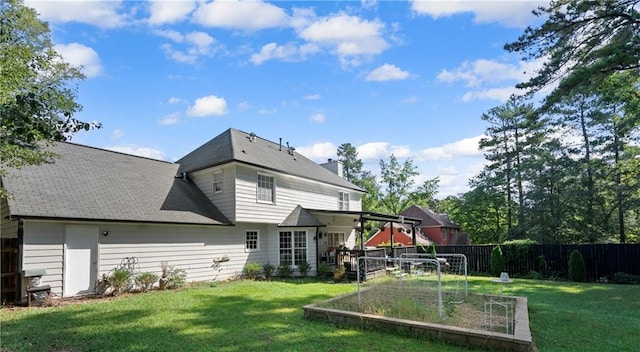 back of house featuring a yard