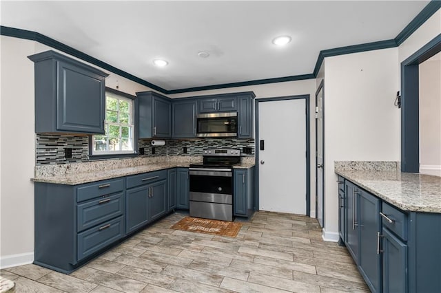 kitchen with light hardwood / wood-style flooring, stainless steel appliances, blue cabinetry, ornamental molding, and light stone countertops