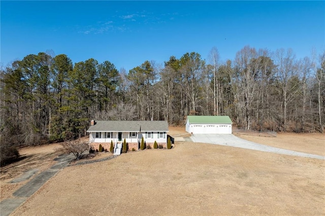 view of front of property with an outbuilding, a porch, and a garage