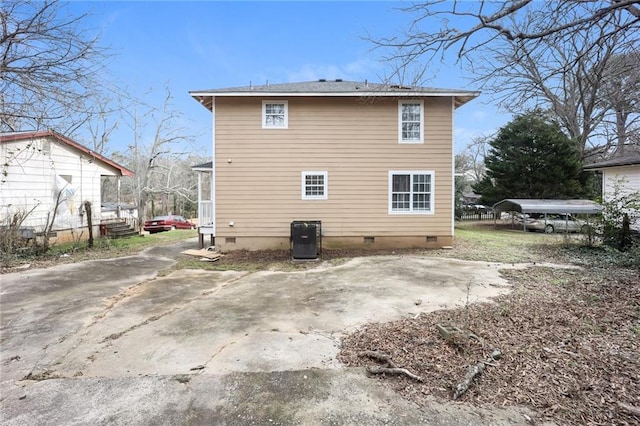 back of house with crawl space and central AC unit