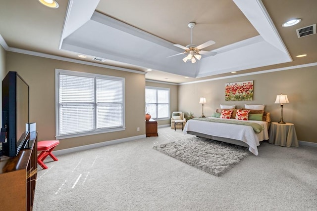 bedroom with a raised ceiling, ornamental molding, light carpet, and ceiling fan