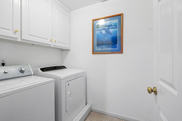 laundry room featuring cabinets and washing machine and clothes dryer