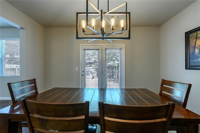 dining space featuring plenty of natural light and an inviting chandelier