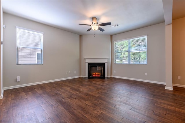 unfurnished living room with ceiling fan and dark hardwood / wood-style flooring