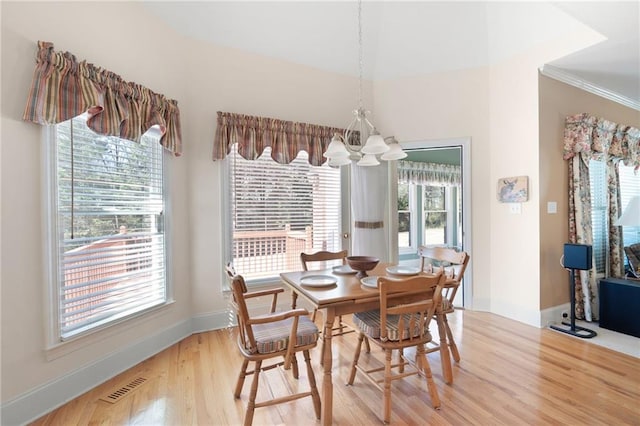 dining space with visible vents, a notable chandelier, light wood-style flooring, and baseboards