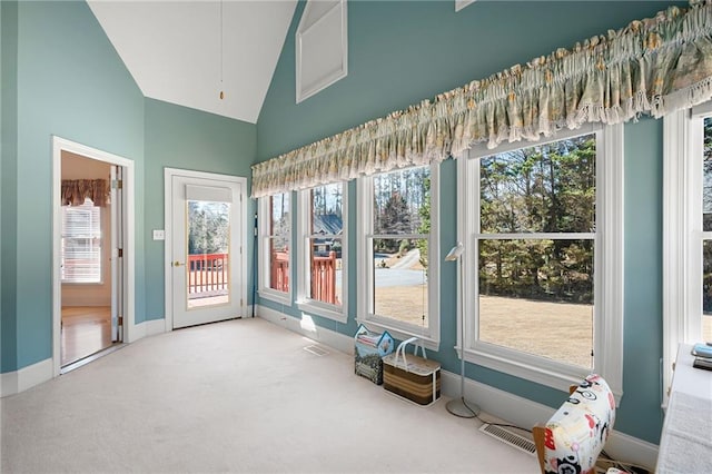 unfurnished sunroom with lofted ceiling, a healthy amount of sunlight, and visible vents