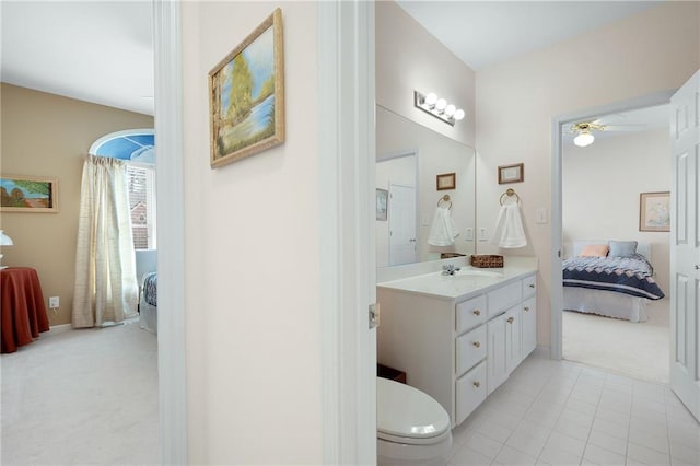 ensuite bathroom with toilet, ceiling fan, vanity, ensuite bath, and tile patterned floors