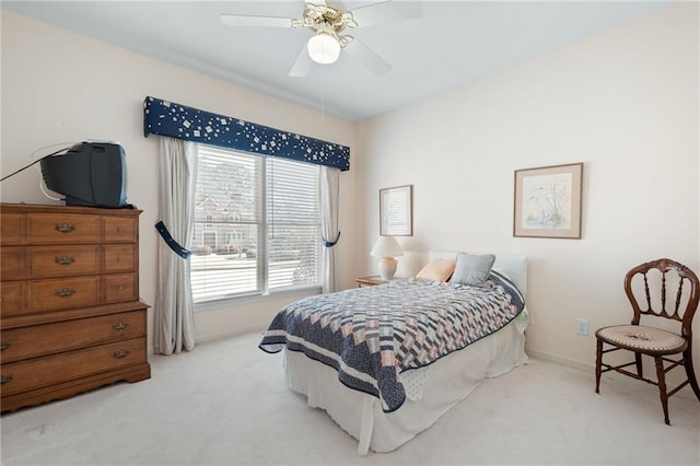 bedroom with a ceiling fan, carpet flooring, and baseboards