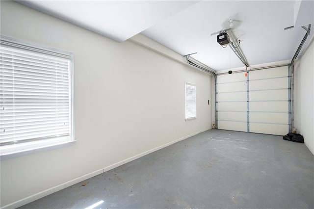 garage featuring a garage door opener and baseboards