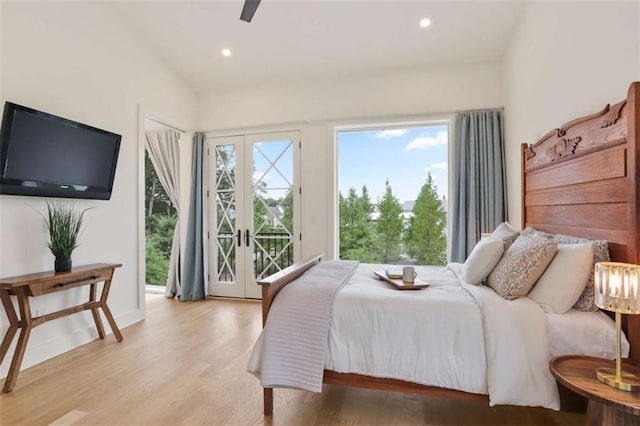 bedroom with french doors, vaulted ceiling, light hardwood / wood-style flooring, ceiling fan, and access to exterior