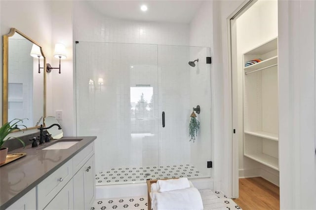 bathroom featuring vanity, wood-type flooring, and an enclosed shower