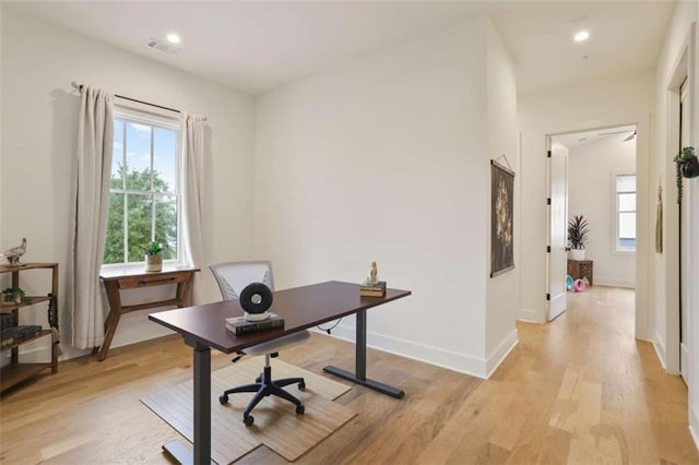 office area with a healthy amount of sunlight and light hardwood / wood-style floors