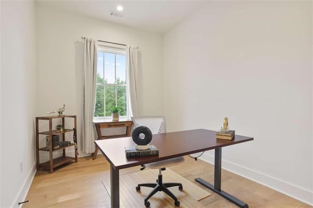 office space with light hardwood / wood-style flooring