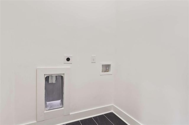 clothes washing area with dark tile patterned floors, washer hookup, and hookup for an electric dryer