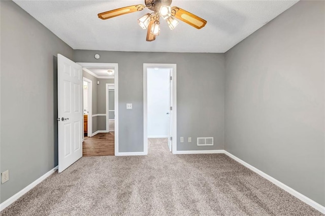 unfurnished bedroom with carpet floors and ceiling fan